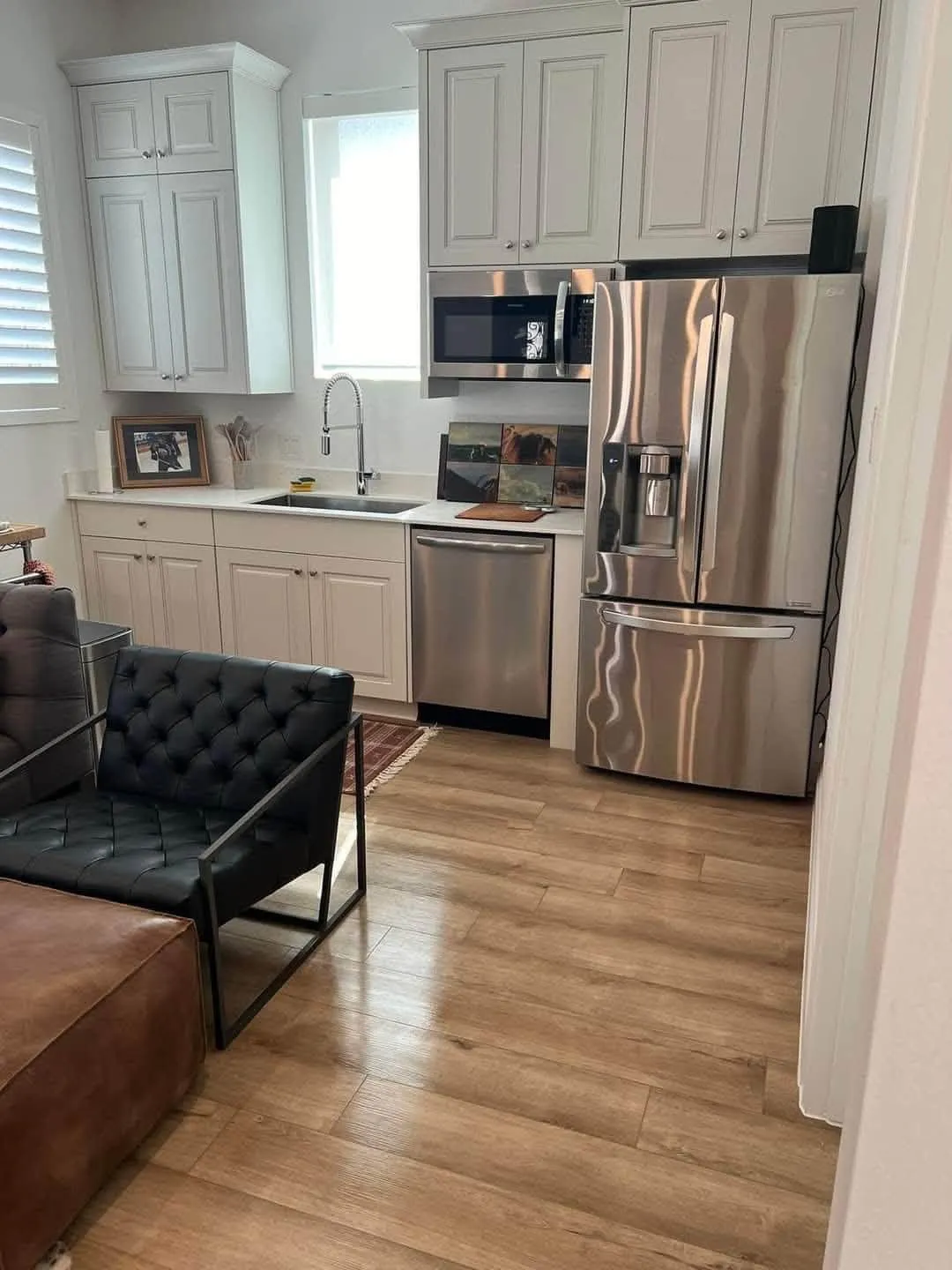 Bright clean kitchen with white cabinets and stainless appliances