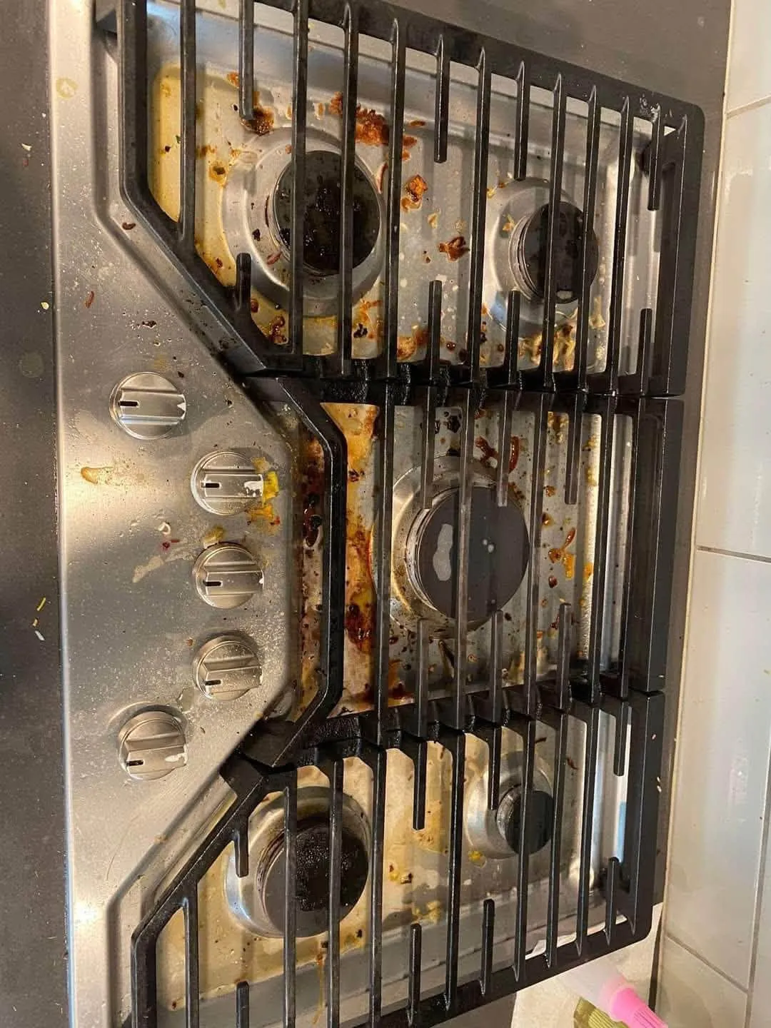 Gas cooktop with heavy spills before cleaning